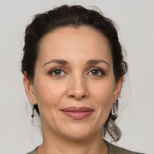 Joyful white adult female with medium  brown hair and grey eyes