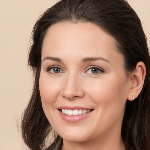 Joyful white young-adult female with medium  brown hair and brown eyes