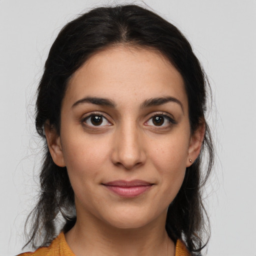 Joyful latino young-adult female with long  brown hair and brown eyes