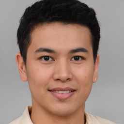 Joyful asian young-adult male with short  brown hair and brown eyes