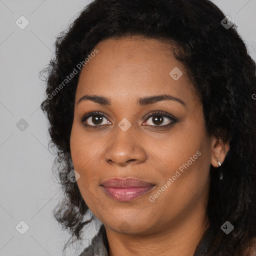 Joyful black young-adult female with long  black hair and brown eyes