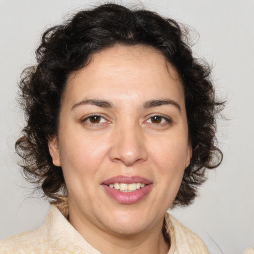 Joyful white adult female with medium  brown hair and brown eyes