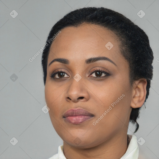 Joyful black young-adult female with short  black hair and brown eyes