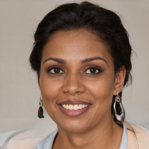 Joyful black young-adult female with medium  brown hair and brown eyes