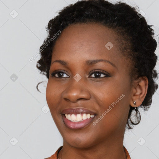 Joyful black young-adult female with long  brown hair and brown eyes