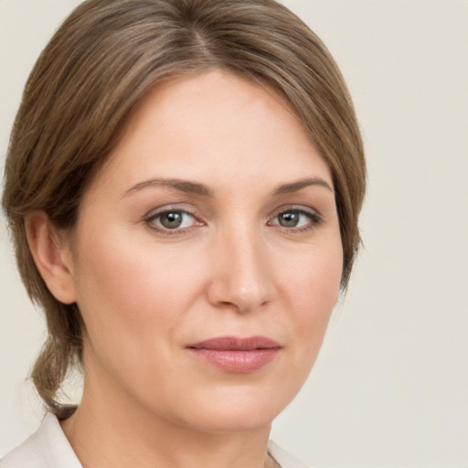 Joyful white young-adult female with medium  brown hair and green eyes