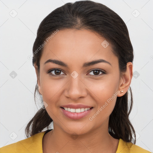 Joyful latino young-adult female with long  brown hair and brown eyes