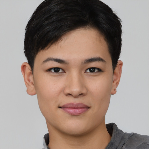 Joyful asian young-adult female with short  black hair and brown eyes