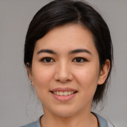 Joyful asian young-adult female with medium  brown hair and brown eyes