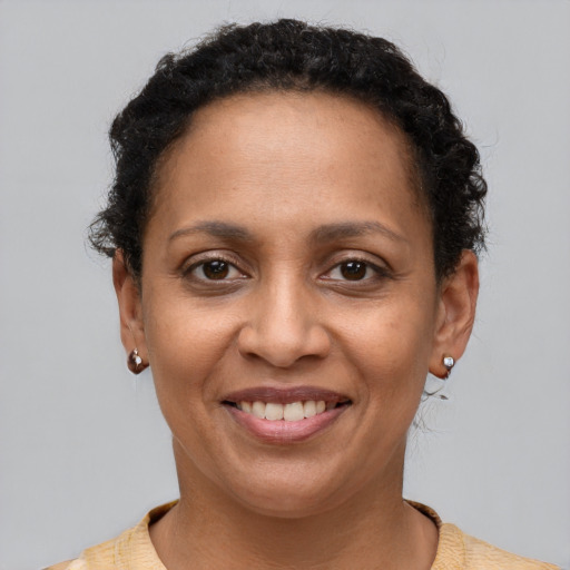 Joyful latino adult female with short  brown hair and brown eyes