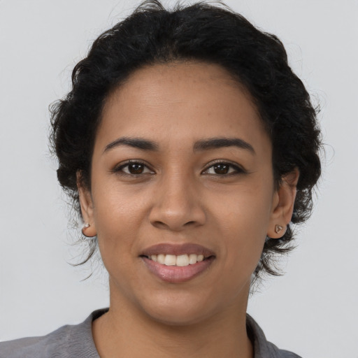Joyful latino young-adult female with long  black hair and brown eyes