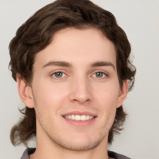 Joyful white young-adult male with medium  brown hair and brown eyes