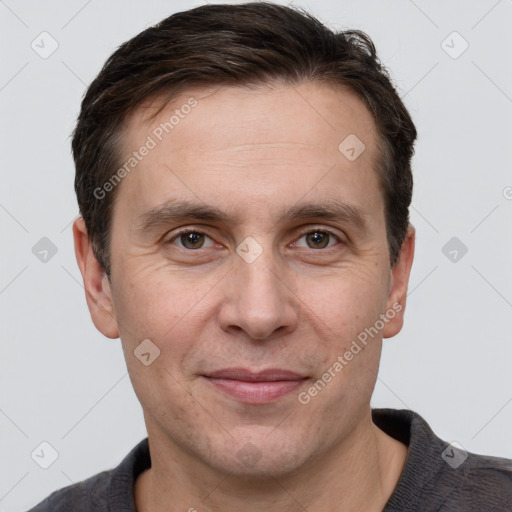 Joyful white adult male with short  brown hair and grey eyes