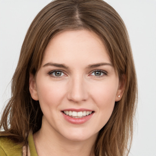 Joyful white young-adult female with long  brown hair and grey eyes