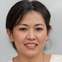 Joyful white adult female with medium  brown hair and brown eyes