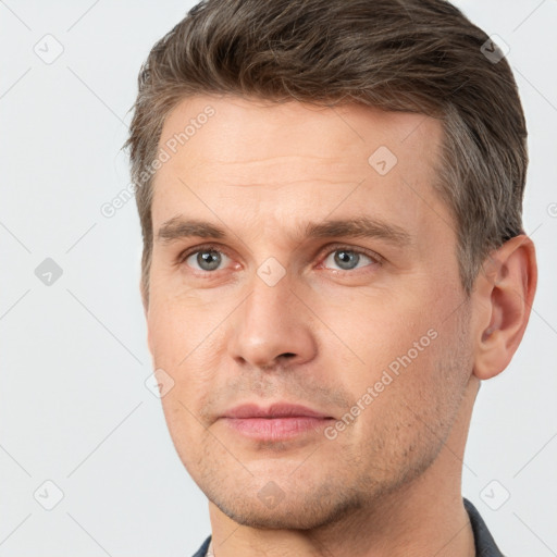 Joyful white adult male with short  brown hair and brown eyes