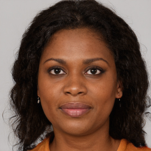 Joyful black young-adult female with medium  brown hair and brown eyes