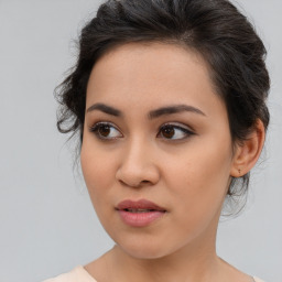 Joyful asian young-adult female with medium  brown hair and brown eyes