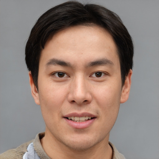 Joyful asian young-adult male with short  brown hair and brown eyes