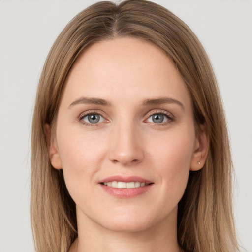 Joyful white young-adult female with long  brown hair and grey eyes