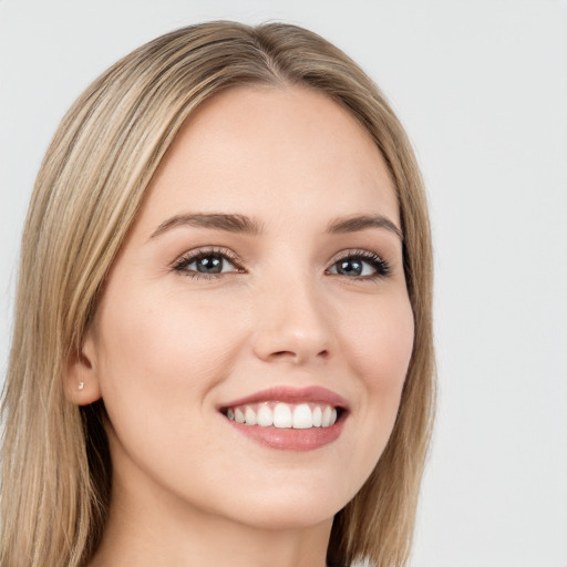 Joyful white young-adult female with long  brown hair and green eyes