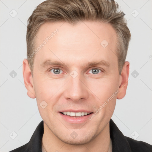 Joyful white adult male with short  brown hair and grey eyes