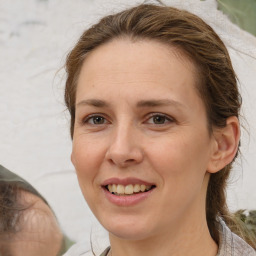 Joyful white adult female with medium  brown hair and brown eyes