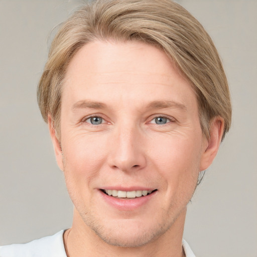 Joyful white adult male with short  brown hair and grey eyes