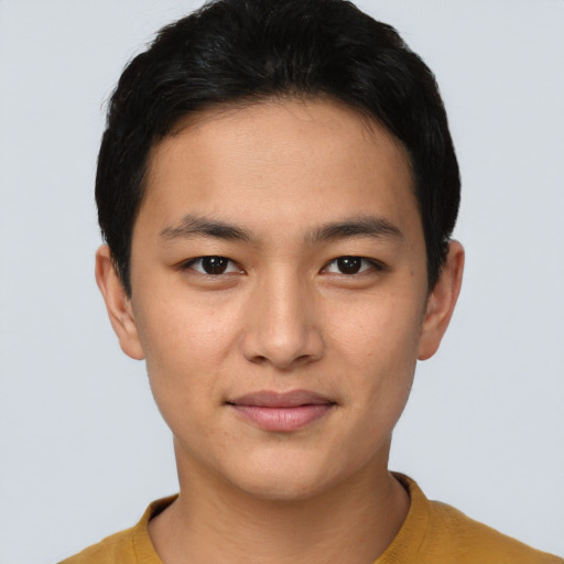 Joyful asian young-adult male with short  black hair and brown eyes