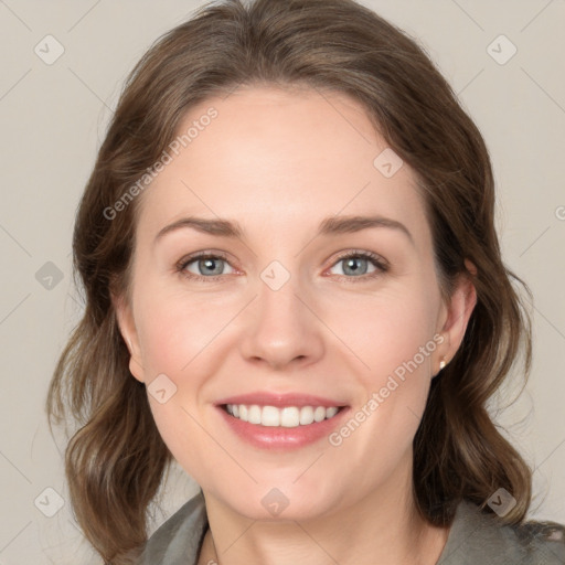 Joyful white young-adult female with medium  brown hair and grey eyes