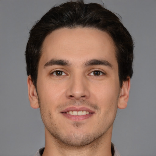 Joyful white young-adult male with short  brown hair and brown eyes