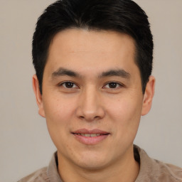 Joyful latino young-adult male with short  brown hair and brown eyes