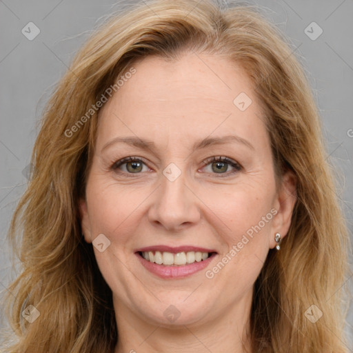 Joyful white adult female with long  brown hair and brown eyes