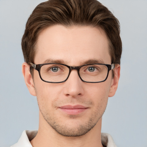 Joyful white young-adult male with short  brown hair and grey eyes