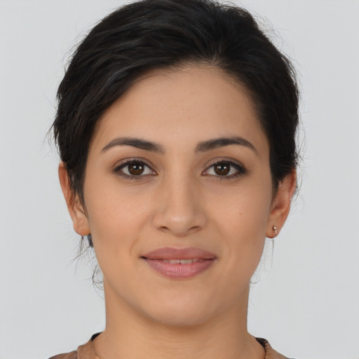 Joyful latino young-adult female with long  brown hair and brown eyes