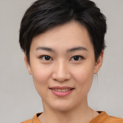 Joyful asian young-adult female with short  brown hair and brown eyes