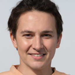 Joyful white adult male with short  brown hair and brown eyes