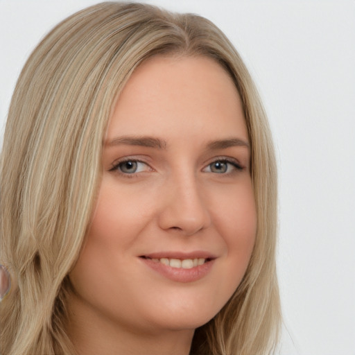 Joyful white young-adult female with long  blond hair and brown eyes