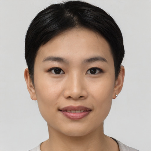 Joyful asian young-adult female with short  black hair and brown eyes
