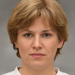 Joyful white adult female with medium  brown hair and grey eyes