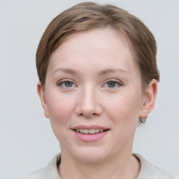 Joyful white young-adult female with short  brown hair and grey eyes