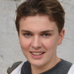 Joyful white young-adult female with short  brown hair and blue eyes