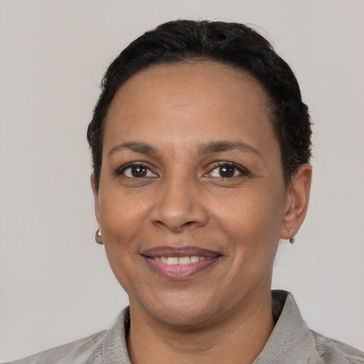 Joyful latino adult female with short  black hair and brown eyes