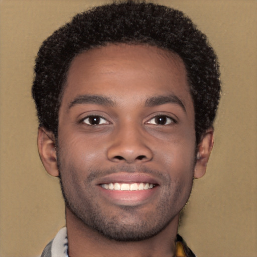 Joyful black young-adult male with short  brown hair and brown eyes