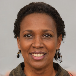 Joyful black adult female with short  brown hair and brown eyes