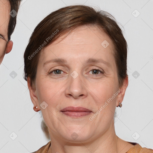 Joyful white adult female with medium  brown hair and grey eyes