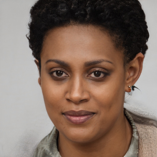 Joyful black young-adult female with short  brown hair and brown eyes
