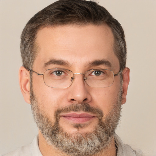 Joyful white adult male with short  brown hair and brown eyes