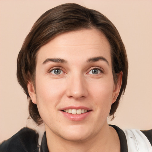 Joyful white young-adult female with medium  brown hair and grey eyes