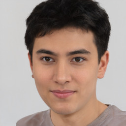 Joyful asian young-adult male with short  brown hair and brown eyes